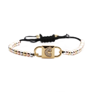 Adjustable black rope bracelet with tri-color metallic beads and gold CZ letter C lock charm