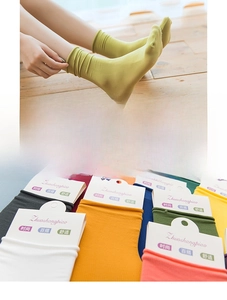 Detailed view of colorful velvet nylon socks showing ribbed texture and elastic cuffs