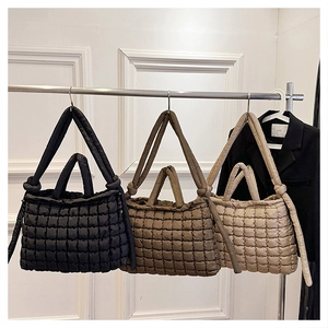 Detailed comparison of quilted tote bags in black and khaki with long shoulder straps