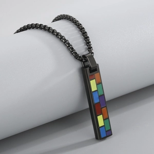 Macro view of a rectangular black military tag pendant with vibrant rainbow grid pattern