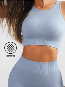 Detail of light blue ribbed fitness set showing high-elastic seamless texture and fit