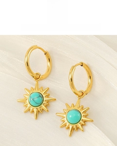 Detailed shot of 18K gold plated starburst earrings with turquoise beads on silk
