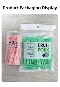 Close-up of pink and green disposable plastic fruit forks in tube and bag packaging