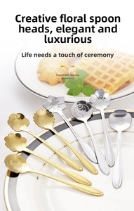 Detailed close-up of mixed gold and silver floral stainless steel spoons on a porcelain plate