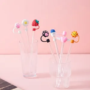 Set of 7 cartoon silicone straw covers with animal and flower shapes on pink background