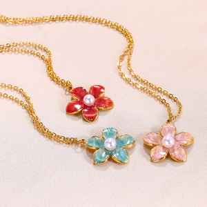 Floral pearl necklace set in red, sky blue, and pink with golden chain on textured background