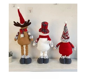 Rear view detail of three Christmas plush dolls featuring retractable legs and grey shoes