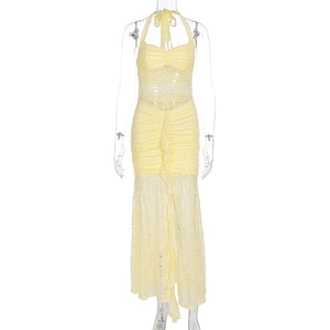 Detail of light yellow lace maxi dress with halter neck and delicate ruched cutouts