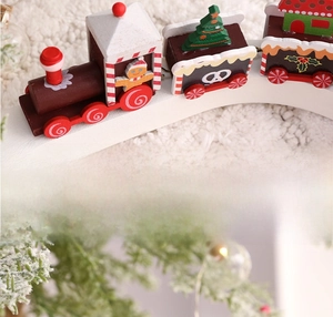 Detail view of wooden Christmas train decor with gingerbread man and festive patterns