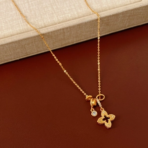 Detail of gold clover pendant necklace with sparkling zircon pavé on a luxury display