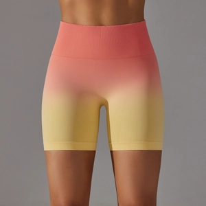 Detail of high waist seamless yoga shorts with pink to yellow gradient and ribbed fabric