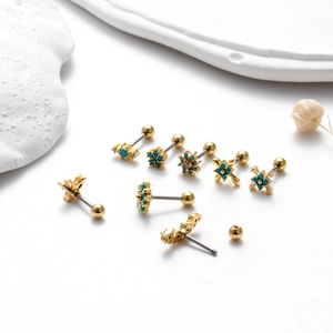 Gold stainless steel stud earrings set with turquoise stones and geometric designs