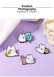 Detailed view of four cartoon cat enamel pins playing instruments on purple background