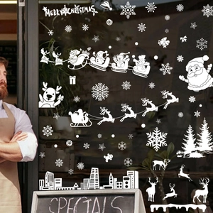 Christmas window decals with reindeer, snowflakes and city silhouette on store glass