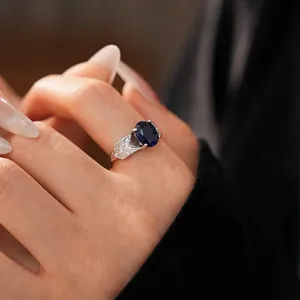 Sparkling silver leaf open ring with large oval deep blue gemstone and pavé zircon accents