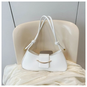 Detail of white PU leather half-moon bag with elegant golden crescent metal buckle