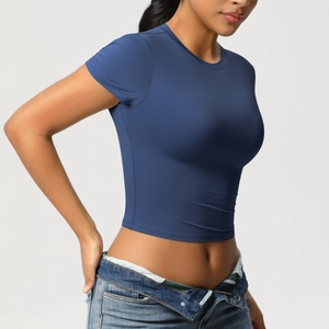 Slim fit navy blue sports crop top paired with high waist jeans on a side view model