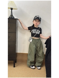 Detail of kids black slogan T-shirt and olive green cargo pants outfit set
