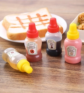 Set of 4 mini squeeze bottles for ketchup and soy sauce on a wooden table setup