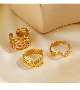 Detailed close-up of a 3-piece 18K gold plated ring set on white silk background
