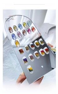 Nail art display showing 22 colors of metallic gold and watercolor smoke marble effect