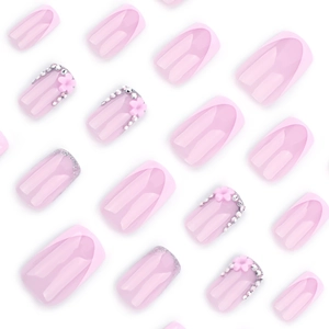Pink French press-on nails with silver glitter, 3D flowers, and sparkling rhinestones