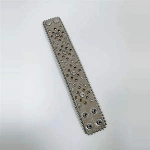 Detail of wide leather bracelet with sparkling rhinestones and metal snap closure