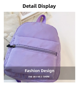 Close-up of purple nylon mini backpack showing smooth texture and zipper detail