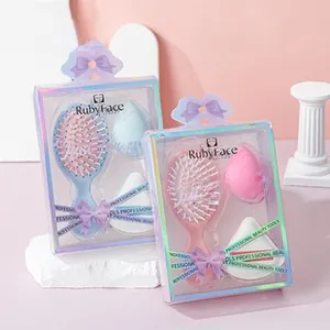 Detailed view of hairbrush and sponge set in pink and blue packaging with bows