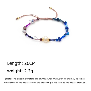 Detail view of handmade braided bracelet with freshwater pearl and colorful beads