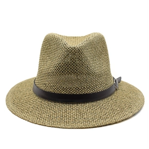Detailed close-up of woven fedora texture with dark faux leather band and metal buckle