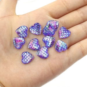 Macro shot of 12mm purple heart resin cabochons with iridescent mermaid scale texture