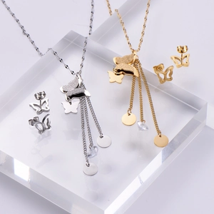 Elegant gold and silver butterfly jewelry set with zircon pendants on display