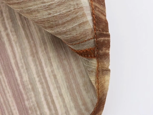 Dettaglio del tessuto in chiffon a righe con cuciture pulite e trama plissettata