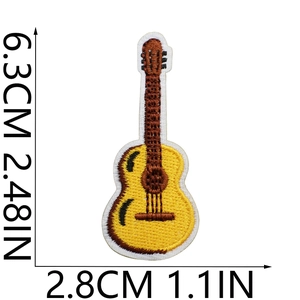 Detailed macro view of yellow guitar embroidery patch with precise size measurements