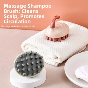 Close-up of pink and grey silicone scalp massager brushes in a clean bathroom setting