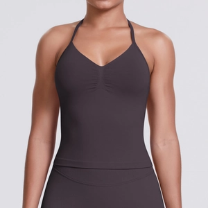 Detail of seamless ribbed sports top with ruched bust and halter neck in dark charcoal