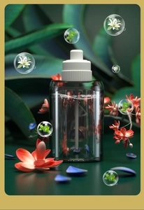 Detailed view of the fragrance bottle with floral elements and essential oil bubbles