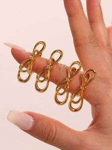 Macro shot of 18k gold plated bow-shaped stackable rings on a model hand