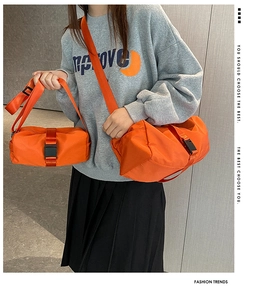 Nylon oxford crossbody bag in vibrant orange showing size comparison on a grey sweatshirt