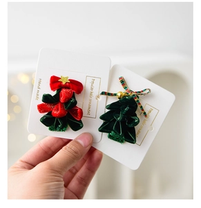 Detailed view of handmade Christmas antler hairpins featuring velvet trees and festive bells