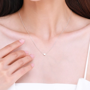 Minimalist S925 sterling silver star necklace pendant shown on a woman neck