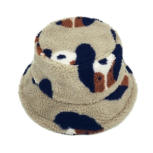 Lambswool bucket hat with cute puppy-style cow print design for winter warmth