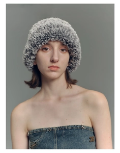 Detail shot of the plush faux fur texture on this warm grey and black knit bucket hat