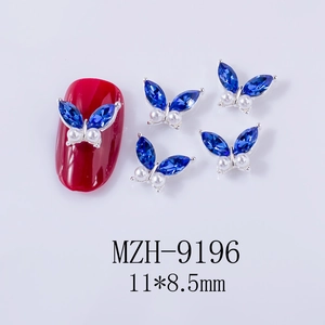 Detailed macro of a 11x8.5mm blue butterfly nail gem with crystal wings and pearls