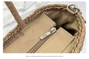 Close-up of the woven straw bag interior showing a zip pocket and fabric lining