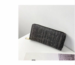 Detailed view of the dark grey striped wallet featuring premium fabric and golden zipper