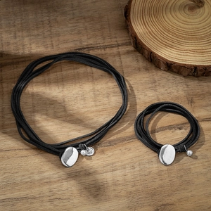 Double-layered black leather choker necklace set with vintage silver round pendants