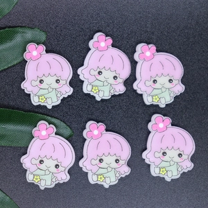Close-up of six pink and green resin Little Twin Stars charms for DIY phone case crafts