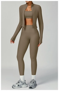 Detail of ribbed knit yoga set featuring a zipper jacket, crop top, and high waist leggings
